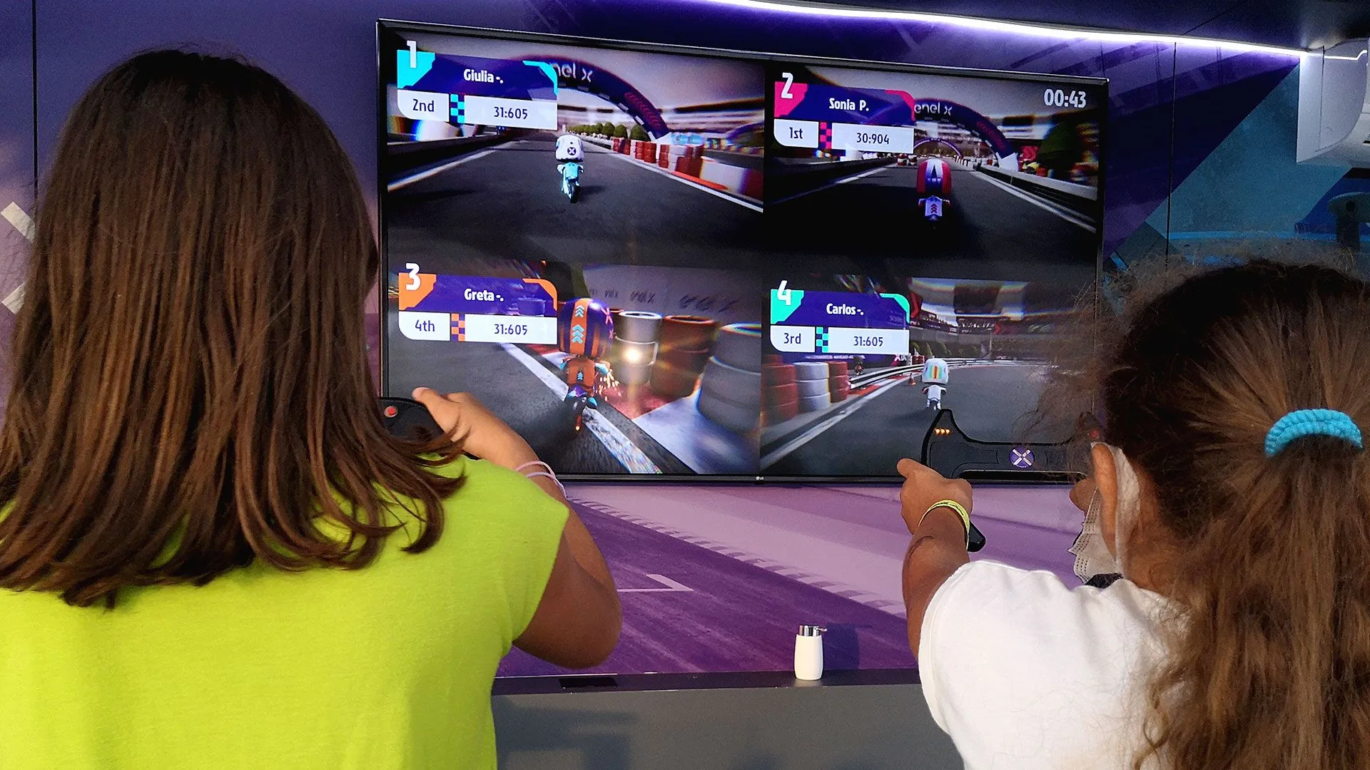 Two visitors playing with the custom wireless controllers.