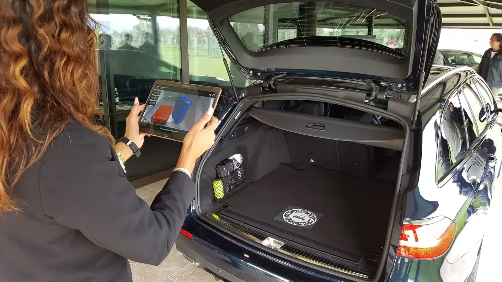 A dealer explores the full model range in augmented reality on a tablet, right at the car.