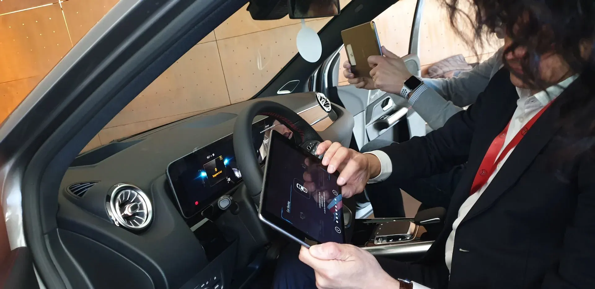 A dealer runs the self-training app from the driver seat during the model launch.