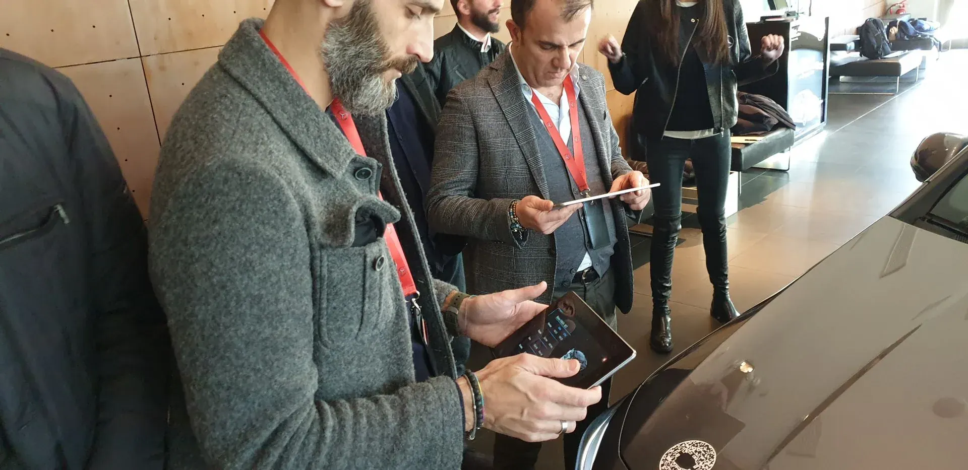 Participants working through the training app on the showroom floor.
